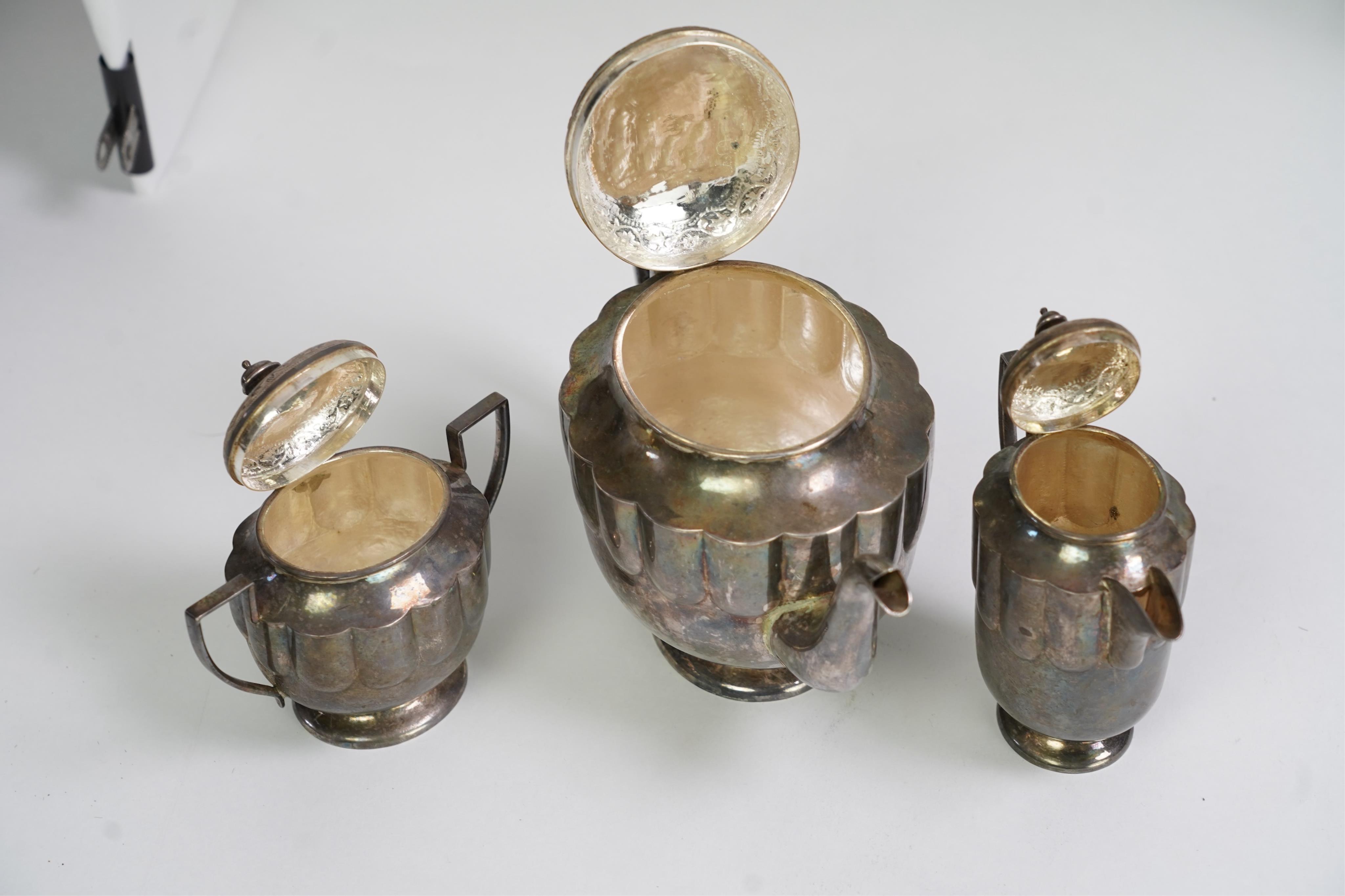 An early 20th century Indian white metal (tests as silver) three piece tea set